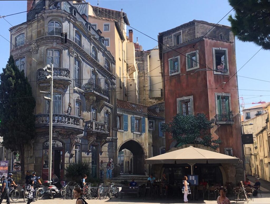 Two flat-front and windowless buildings in Montpelier, France are beautifully painted in "trompe l'oeil" (realistic) style so that they appear to have windows and balconies.