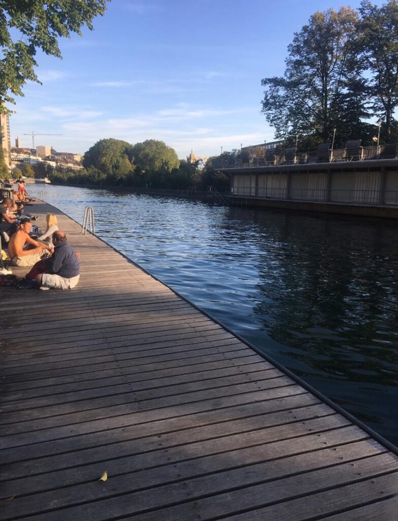 View of the long wooden deck along the Upper Letten canal in Zurich, Switzerland.