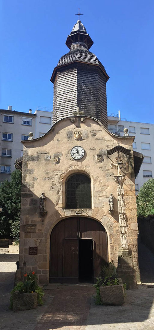 Front entrance to St-Aurelianus Chapel, built out of tan stone in the 15C in Haute-Vienne, France.