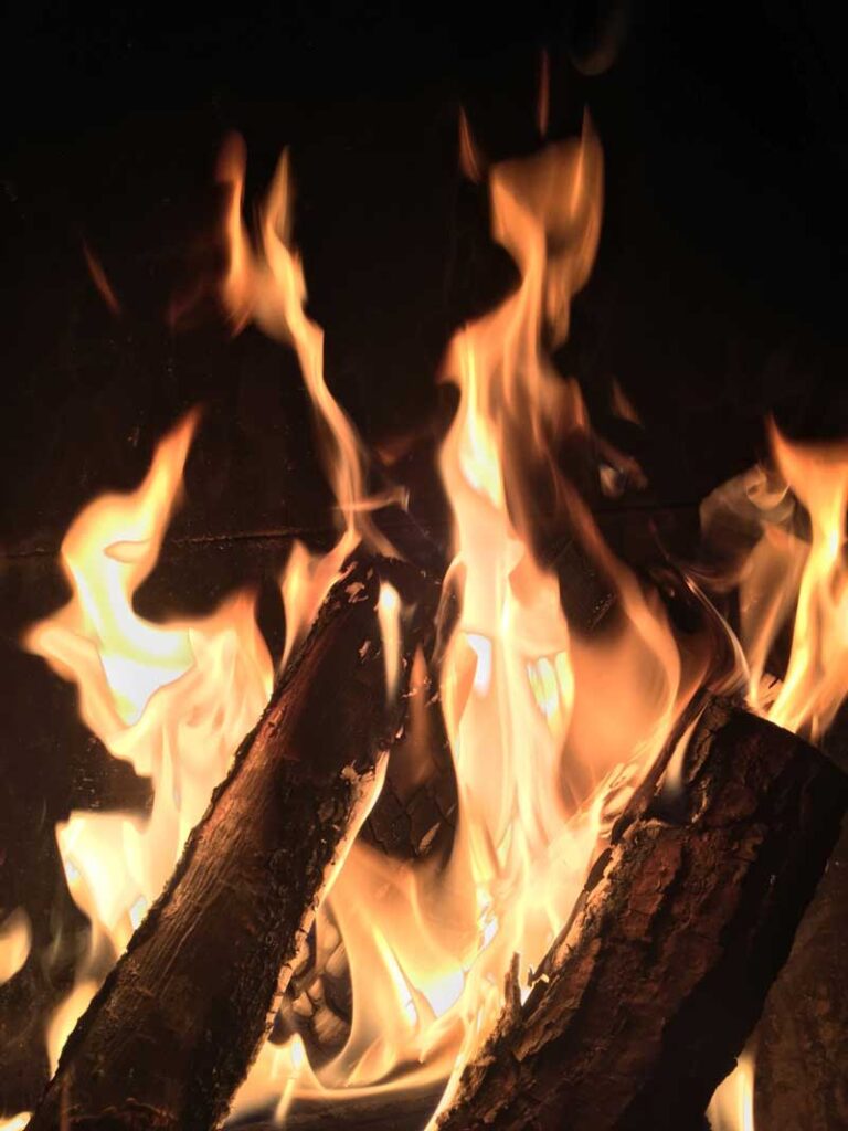 A fire burns at night.