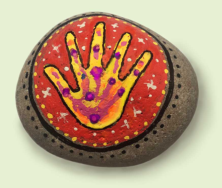 A round HAND STONE, painted by Ralph Williams.