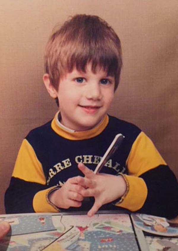 Family photo of Antoine Gee at age 5, sitting at a table and looking cute.