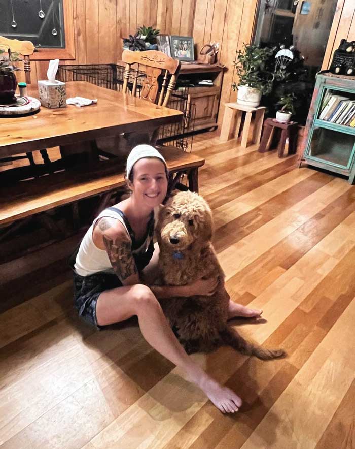 Misa Miller sits on the floor with her new puppy, "Waffle", in Boone, NC.