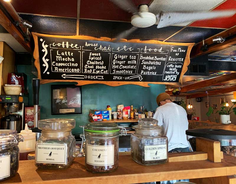 A male barista (with back turned) is hard at work behind The Alley Cat bar.