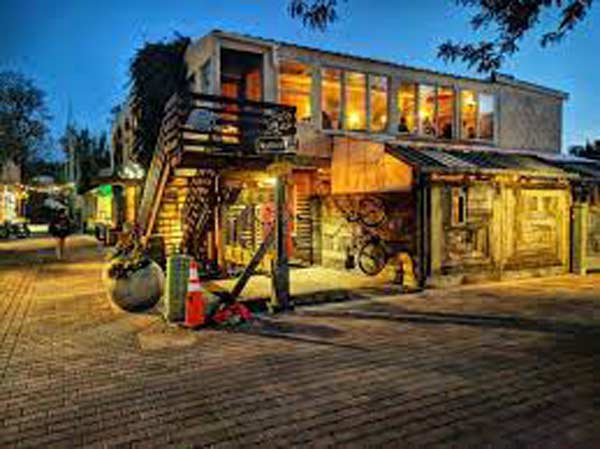 Exterior view of the ALLEY CAT CAFE at dusk.