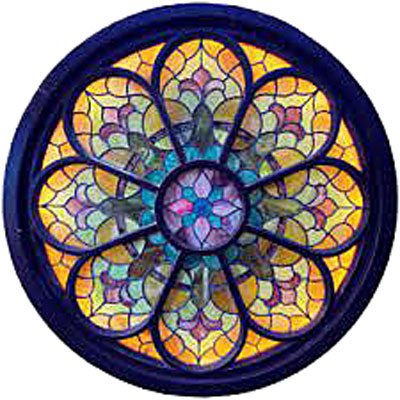 A large, round, colorful stained-glass piece with dark trim is installed behind stage at The Atrium in Fort Collins, CO.