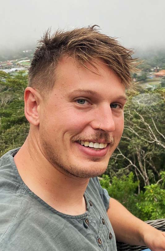 A smiling and casual headshot (taken in Costa Rica) of Hunter Horsfall, co-owner of The Atrium Bar in Fort Collins, CO.