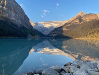 "Mirror, mirror on the lake, is it real or is it fake?" Oh, it's real alright! Lake Louise in Banff, Canada was so still this particular morning that the surrounding landscape cast a mirror-like reflection on the surface of the water. Try turning the image upside down—it's almost identical!