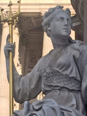At the entrance to Saint Paul's Cathedral is a sculpture of "Britannia" (Great Britain) with a gilded trident in hand and sitting at the base of a standing statue of Queen Anne (Britain's ruling monarch, 1702-1707).