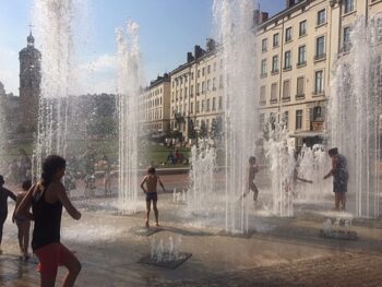 Kids frolic in a geyser-like water feature in August. Why not?!!