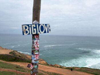BIG KUDOS to the person who mounted this epic sign along the big-wave shores of Nazare, Portugal. Big blue sign that says "BIG LOVE" in white letters is mounted on a wood pole on a bluff overlooking the ocean in Nazare, Portugal.